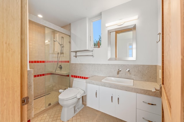 bathroom with vanity, toilet, an enclosed shower, and backsplash