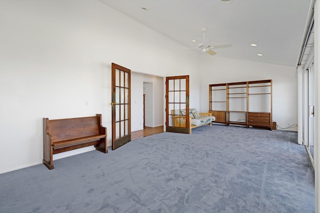 interior space featuring ceiling fan, dark carpet, lofted ceiling, and french doors