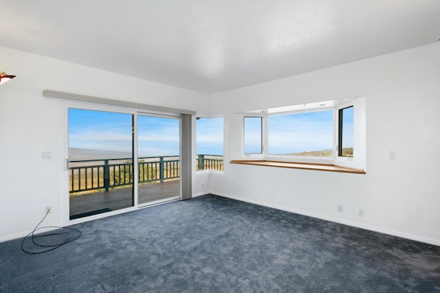 unfurnished room with dark colored carpet