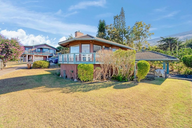 view of front facade featuring a deck and a front lawn