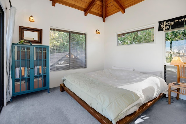 carpeted bedroom featuring vaulted ceiling with beams and wood ceiling