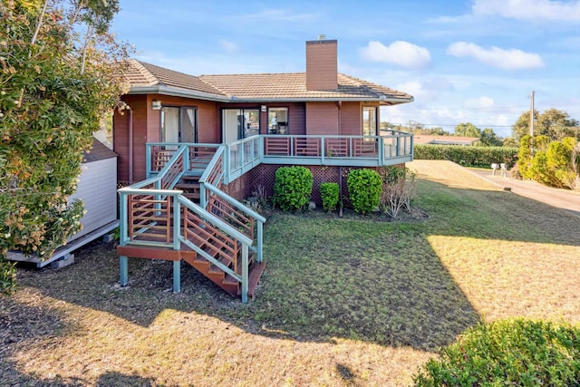 rear view of property featuring a yard