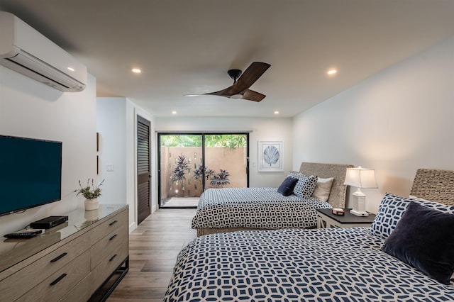 bedroom with hardwood / wood-style floors, access to outside, an AC wall unit, and ceiling fan