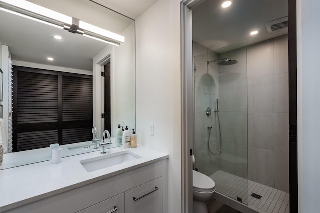 bathroom with vanity, hardwood / wood-style flooring, toilet, and walk in shower