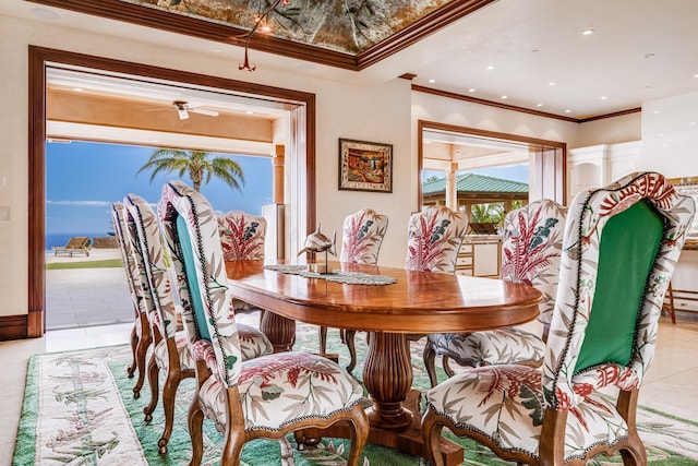 tiled dining space featuring ceiling fan, a healthy amount of sunlight, and crown molding