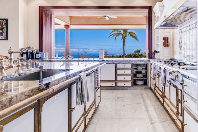 kitchen with decorative backsplash, custom exhaust hood, sink, wine cooler, and stainless steel gas stovetop