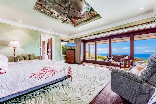 bedroom with hardwood / wood-style floors, access to outside, a raised ceiling, and crown molding