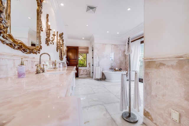 bathroom featuring a washtub, vanity, and ornamental molding