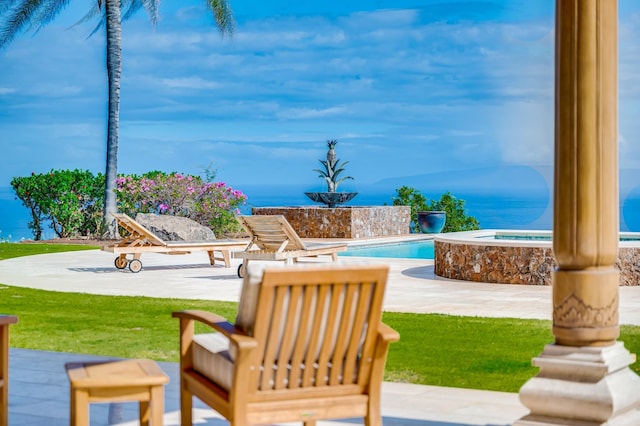 exterior space featuring a pool with hot tub