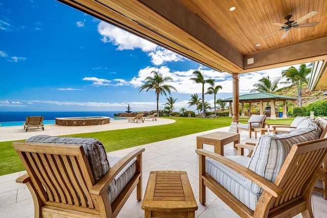 view of patio with a gazebo, an outdoor hangout area, a water view, and ceiling fan