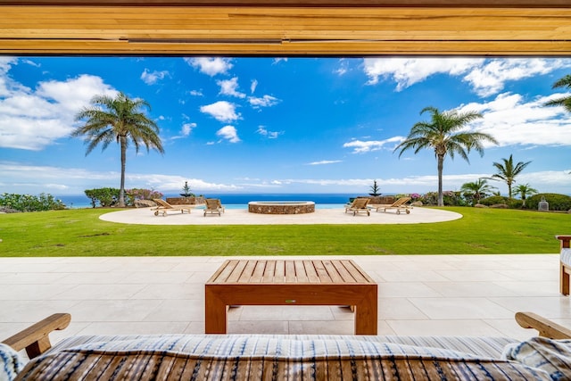 view of patio / terrace featuring a water view and an outdoor fire pit