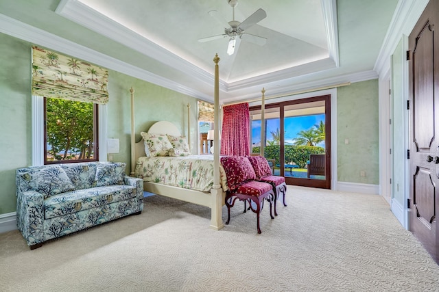 carpeted bedroom featuring ceiling fan, a raised ceiling, crown molding, and access to outside