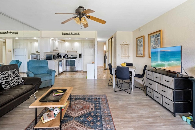 living area featuring a ceiling fan and light wood-style floors