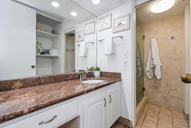 full bathroom with a stall shower, recessed lighting, vanity, and tile patterned floors