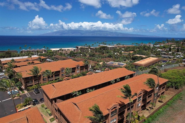 birds eye view of property with a water and mountain view