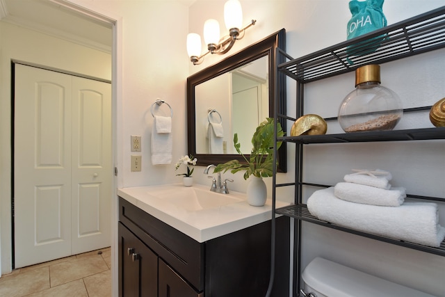 bathroom featuring tile patterned flooring, vanity, toilet, and ornamental molding