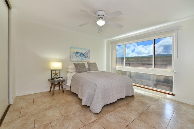 bedroom featuring a closet, ceiling fan, and light tile patterned flooring