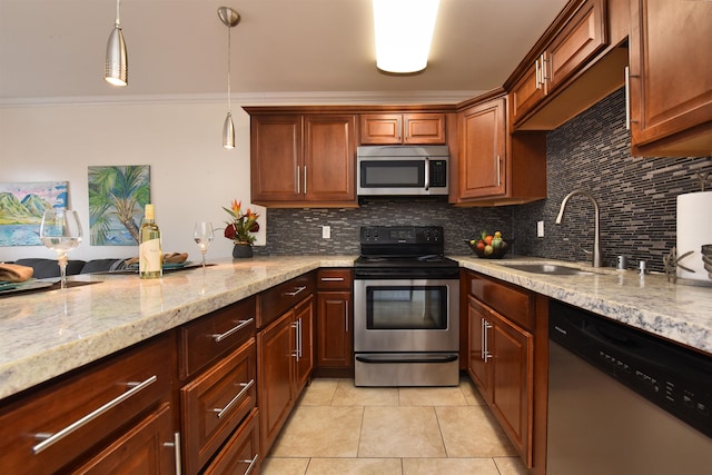 kitchen with light tile patterned floors, sink, light stone countertops, hanging light fixtures, and appliances with stainless steel finishes