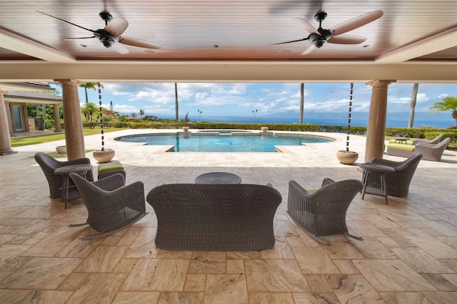 view of swimming pool with ceiling fan, a water view, an in ground hot tub, and a patio