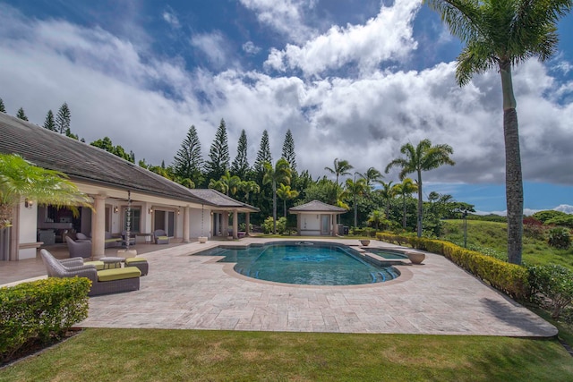 view of swimming pool with a patio, a yard, an outbuilding, and an outdoor hangout area