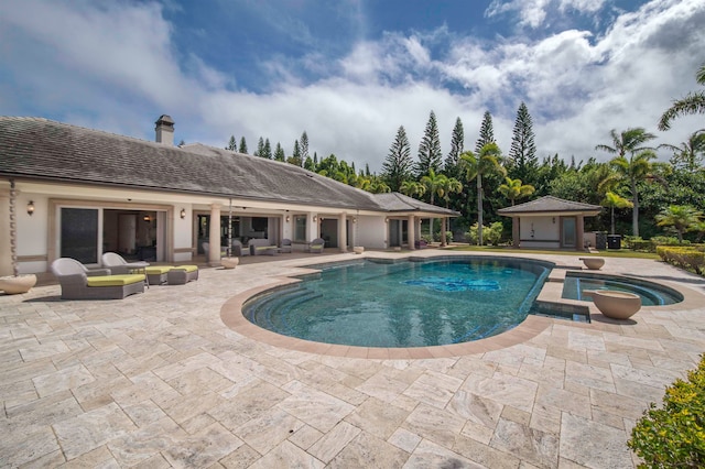 view of pool featuring an in ground hot tub, an outdoor living space, and a patio area