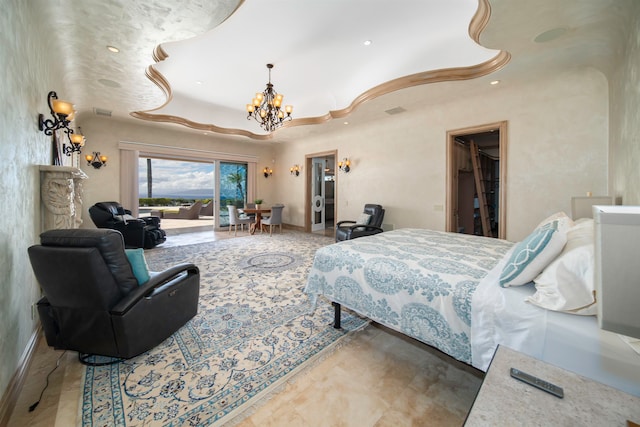 bedroom with a closet, a chandelier, and a walk in closet