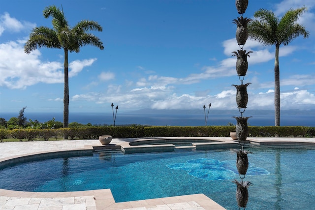 view of pool featuring a water view and an in ground hot tub