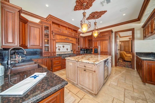 kitchen featuring tasteful backsplash, dark stone counters, a kitchen island, decorative light fixtures, and ornamental molding