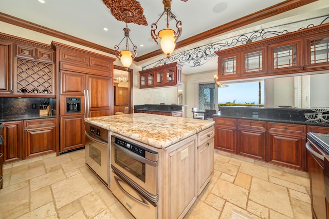 kitchen featuring pendant lighting, a kitchen island, backsplash, stainless steel appliances, and crown molding