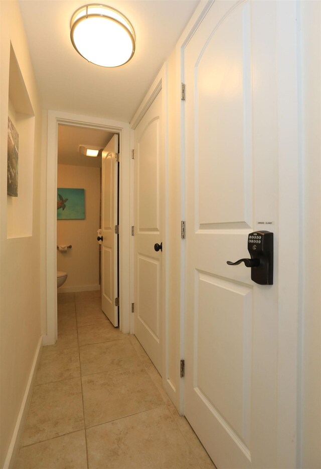 hall with light tile patterned floors