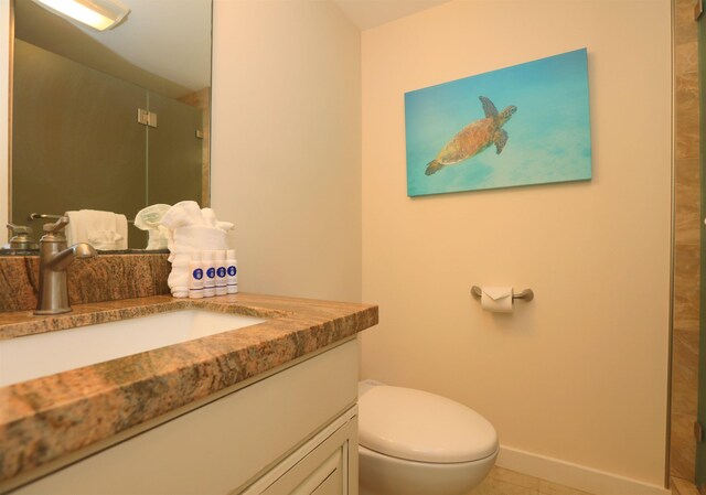 bathroom featuring vanity, toilet, and tile patterned floors