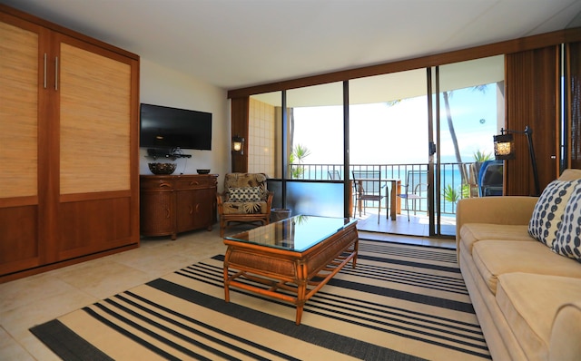 living room with expansive windows, light tile patterned floors, and a healthy amount of sunlight