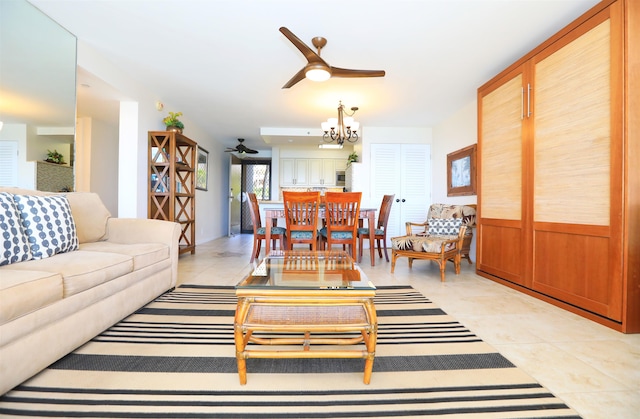 tiled living room featuring ceiling fan with notable chandelier