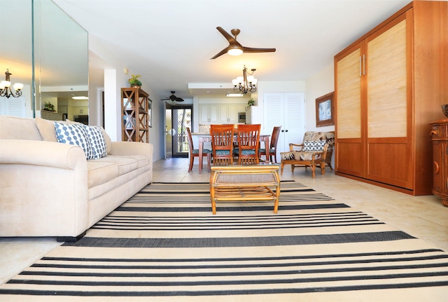 tiled living room with ceiling fan with notable chandelier