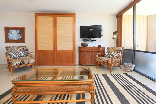 living room with a healthy amount of sunlight and a wall of windows