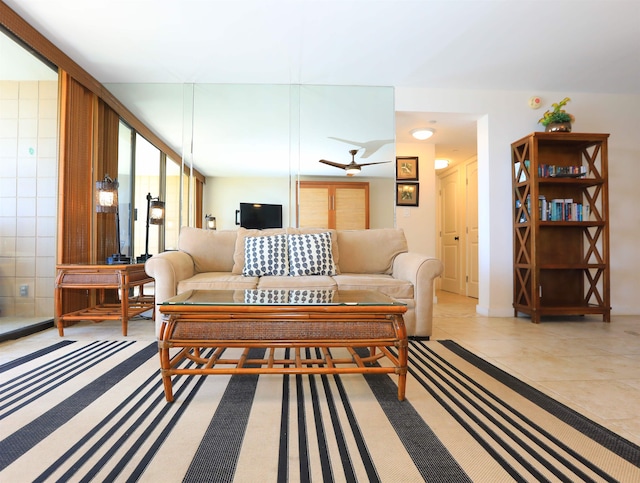 tiled living room featuring tile walls and ceiling fan