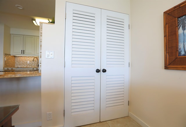 room details featuring tile patterned flooring and tasteful backsplash