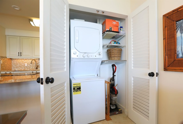 laundry room featuring stacked washer and clothes dryer