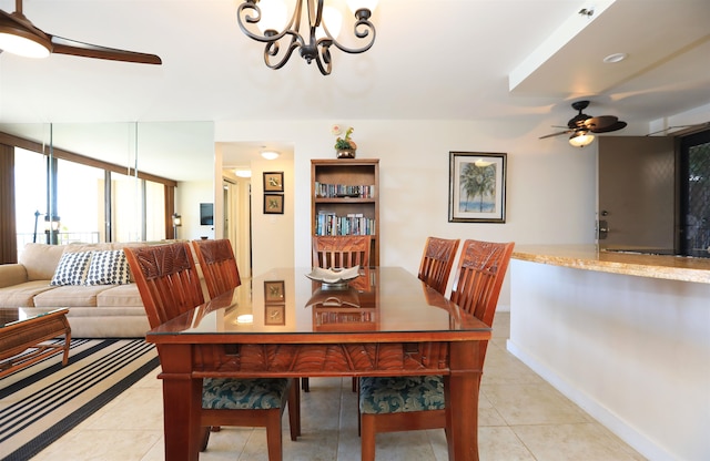 tiled dining space featuring ceiling fan with notable chandelier