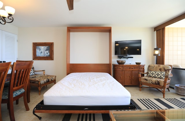 bedroom featuring ceiling fan with notable chandelier