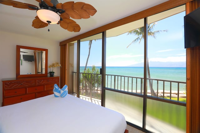 bedroom featuring a water view, ceiling fan, access to outside, and a beach view