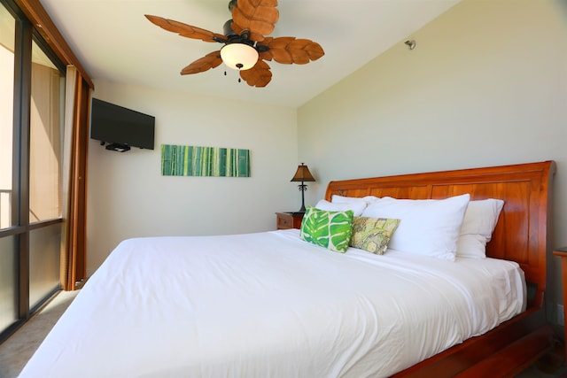 bedroom with vaulted ceiling, ceiling fan, and carpet flooring