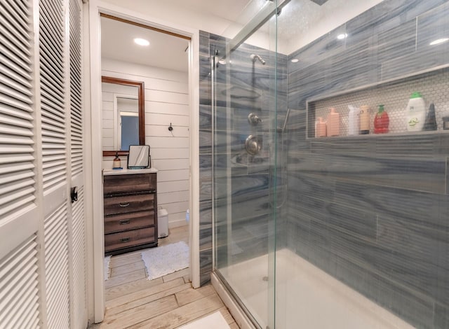 bathroom featuring wood-type flooring, vanity, and walk in shower