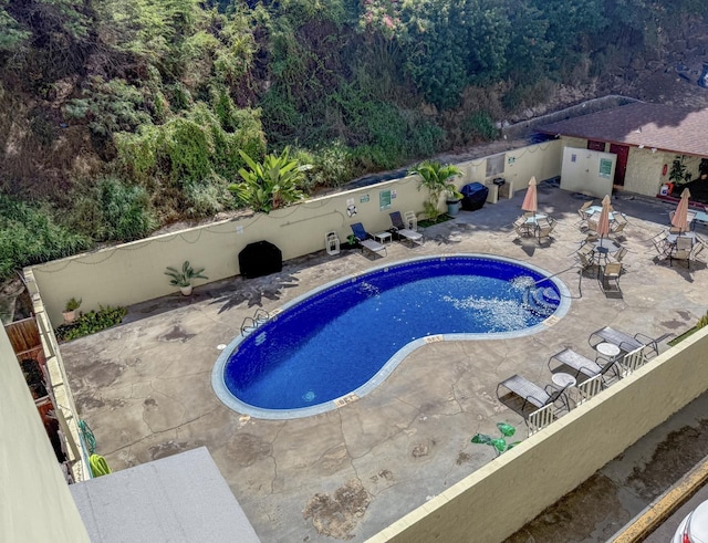 1063 Lower Main St Unit 315, Wailuku, HI 96793 - view of swimming pool featuring a patio and a wooded view