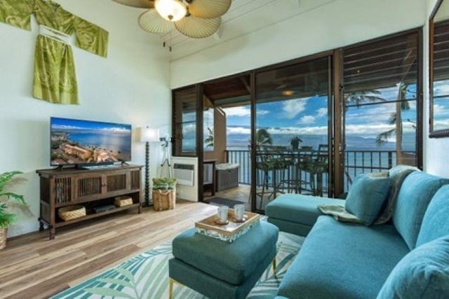 living room featuring hardwood / wood-style floors and ceiling fan