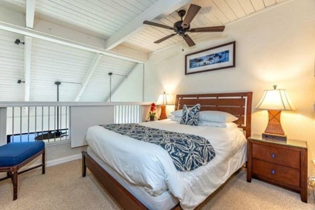 carpeted bedroom with vaulted ceiling with beams, ceiling fan, and wood ceiling