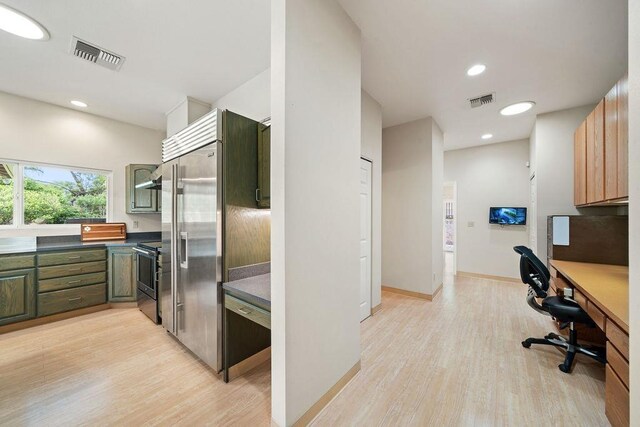 61 Huluhulu Pl, Kahului, HI 96732 - kitchen featuring stainless steel appliances, light wood-type flooring, a desk, dark countertops, and green cabinetry