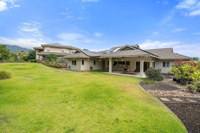 61 Huluhulu Pl, Kahului, HI 96732 - rear view of property with solar panels, a lawn, a patio, and stucco siding
