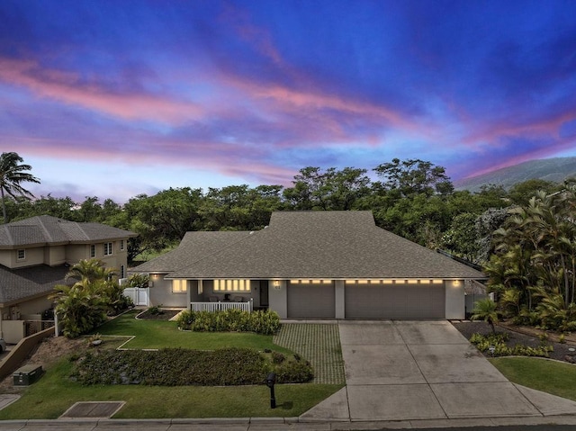 61 Huluhulu Pl, Kahului, HI 96732 - view of front of house featuring an attached garage, driveway, roof with shingles, stucco siding, and a porch