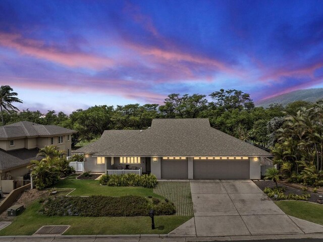 61 Huluhulu Pl, Kahului, HI 96732 - view of front of house featuring an attached garage, driveway, roof with shingles, stucco siding, and a porch